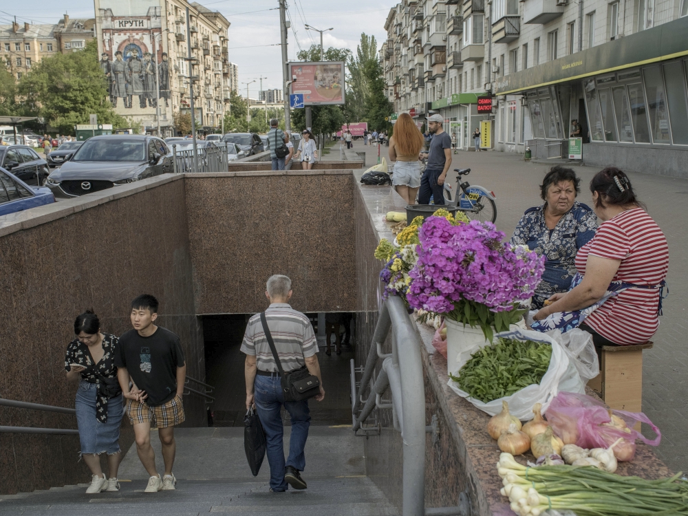 Wang Zheng, 23, who is from China and has been studying in Ukraine since 2017, exits the metro with his girlfriend in Kyiv.