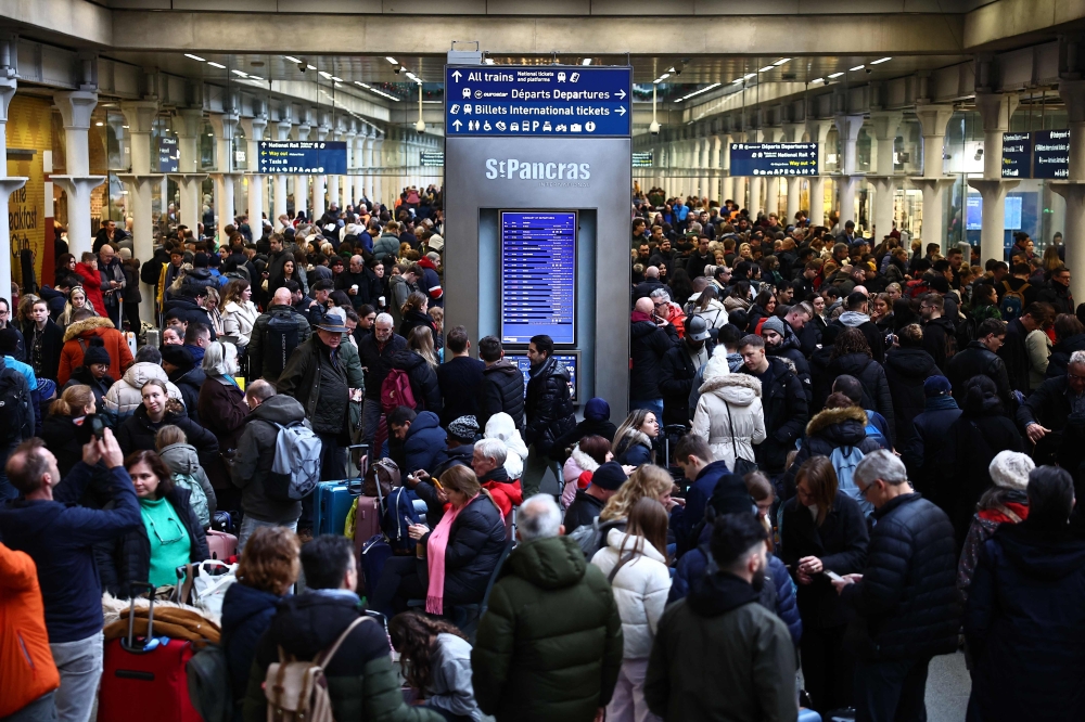 Passengers wait for news of Eurostar departures at St Pancras station in London. — AFP 