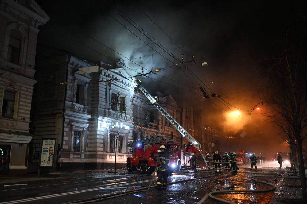 Firefighters extinguish a fire in a building after a Russian drone attack in Kharkiv, Ukraine. — AFP