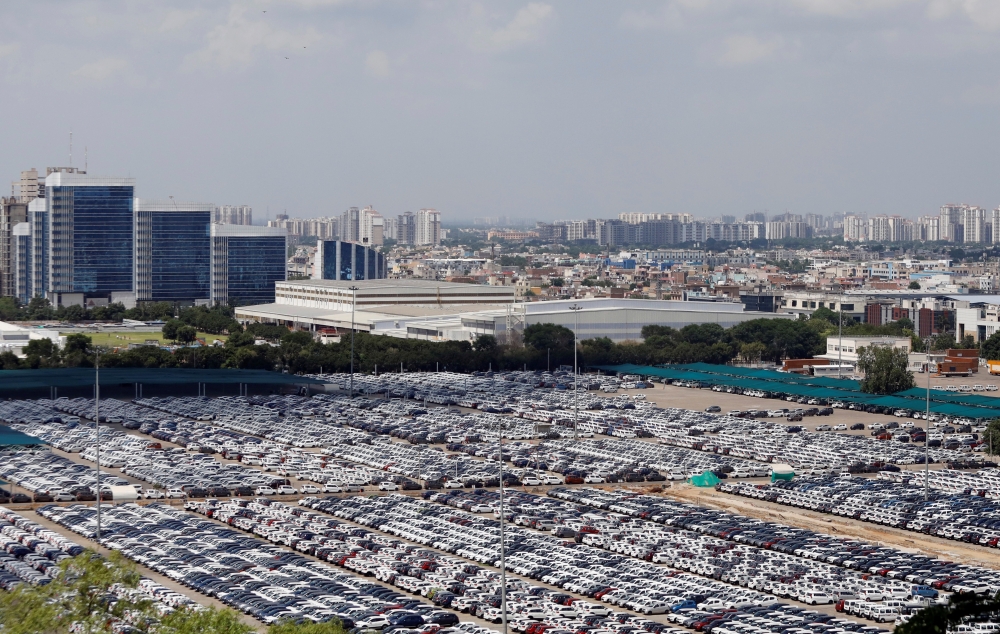 Cars are seen parked at Maruti Suzuki's plant at Manesar