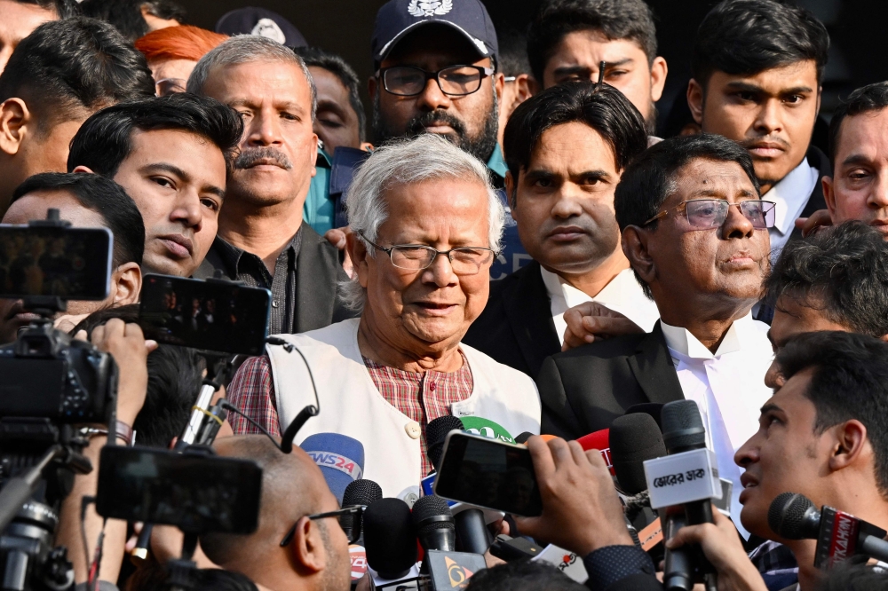 Muhammad Yunus (C) step out of a court in Dhaka on Monday. — AFP 
