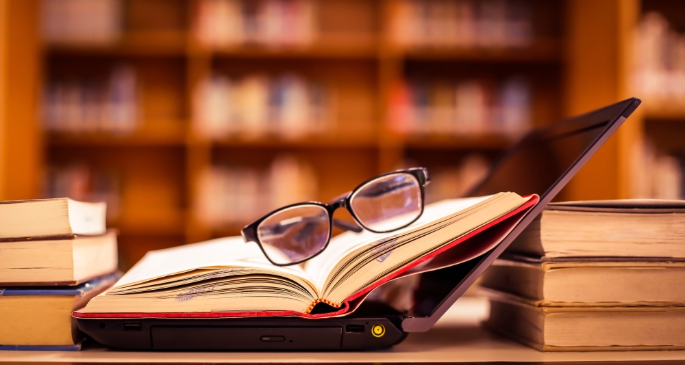 Stack,Of,Books,With,Glasses,Placed,On,The,Open,Book