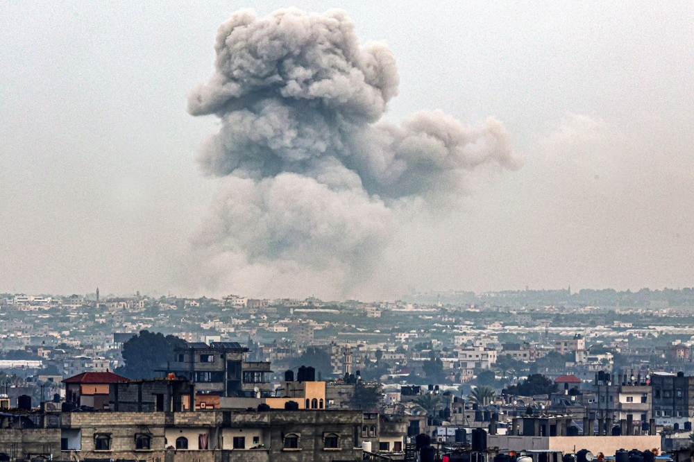 Smoke billows over Khan Yunis from Rafah in the southern Gaza strip during Israeli bombardment. — AFP 