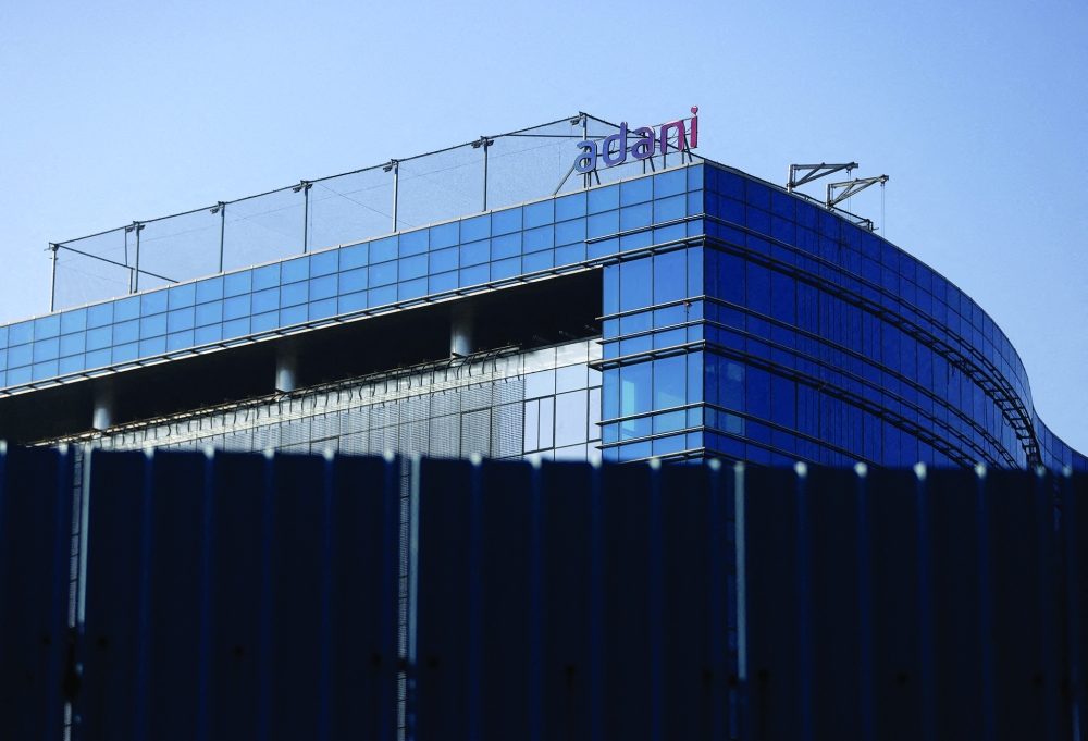A logo of the Adani Group is seen on a commercial complex in Mumbai