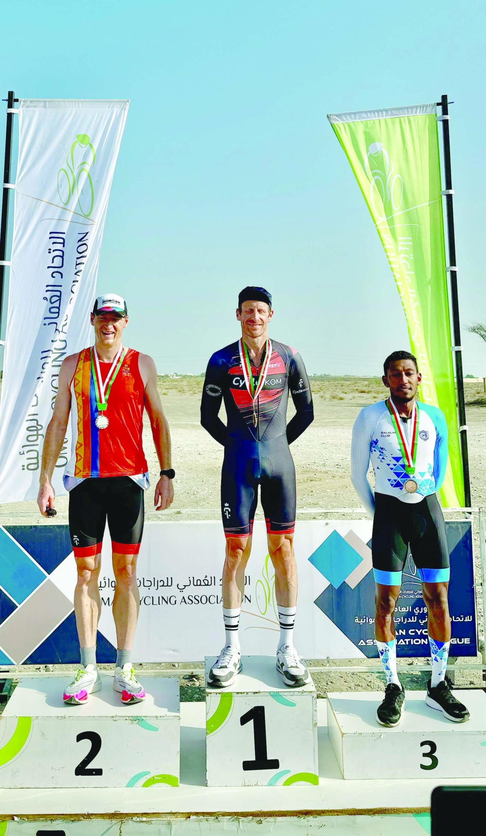 Cycle KOM's Paul Willcox, David Hynes and Salalah Club’s Abdulrahman al Yaqoobi pose on the podium.