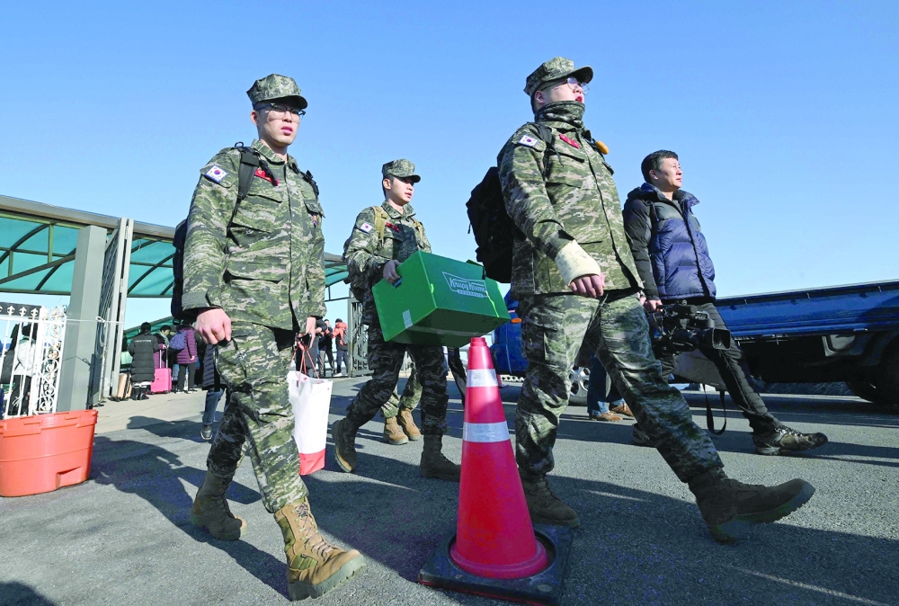 South Korean marines disembark from a passenger ferry at Yeonpyeong island, near the 'northern limit line' sea boundary with North Korea. — AFP 