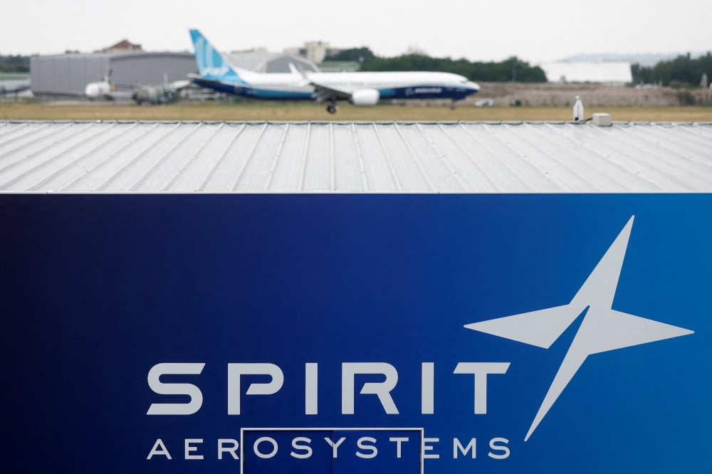 A Boeing 737 MAX-10 lands over the Spirit AeroSystems logo during a flying display at the 54th International Paris Air Show 