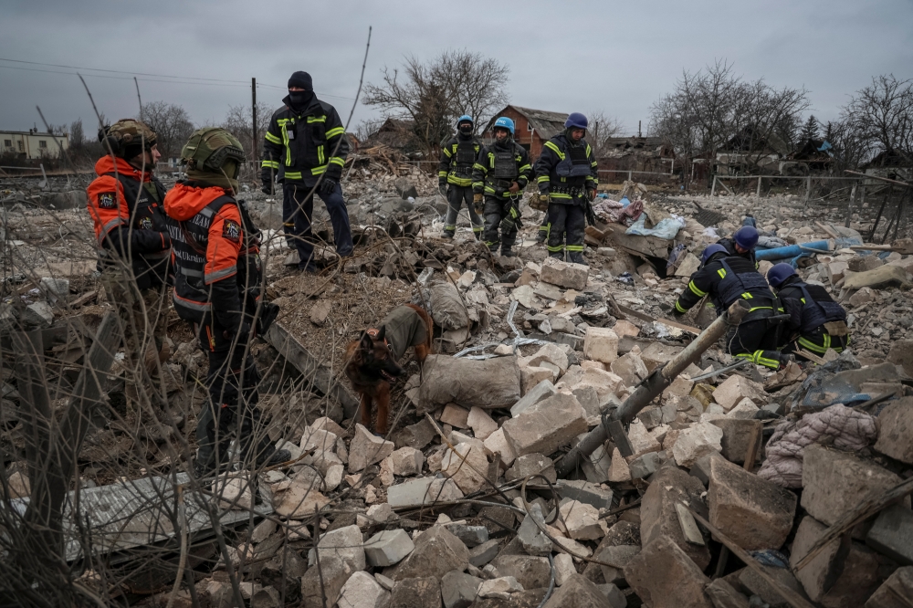 Rescuers with a dog work at the site of a Russian missile strike in an area in the village of Rivne near the Pokrovsk town, in Donetsk region, Ukraine. — Reuters 