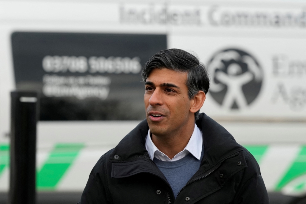 Britain's Prime Minister Rishi Sunak speaks to members of the Environment Agency during a visit to Oxford, England. — Reuters 