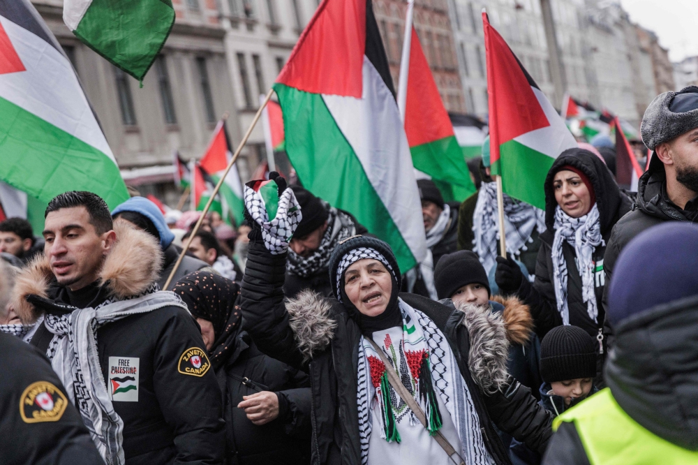 Protesters at the "All Denmark on the Streets for Palestine - Ceasefire Now!" demonstration organized by a broad gathering of solidarity groups and activists are seen on their way from Frederiksberg City Hall to Copenhagen City Hall, in Denmark. — AFP 
