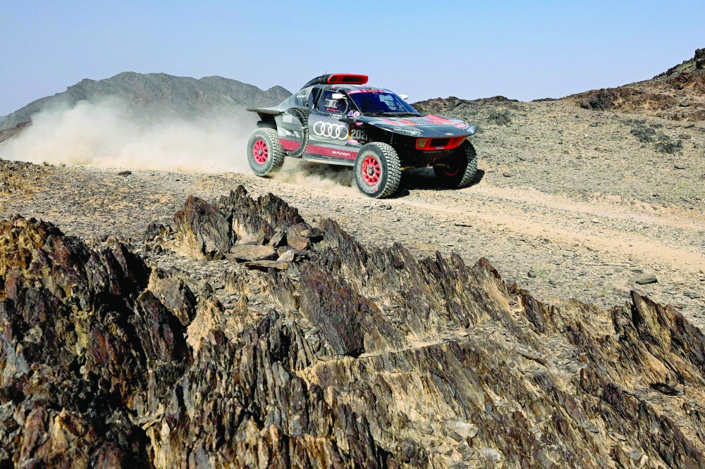 CORRECTION / Audi's French driver Stephane Peterhansel and his French co-driver Edouard Boulanger steer their car during Stage 2 of the Dakar Rally 2024, between Al Henakiyah and Al Duwadimi, Saudi Arabia, on January 7, 2024. (Photo by PATRICK HERTZOG / AFP)