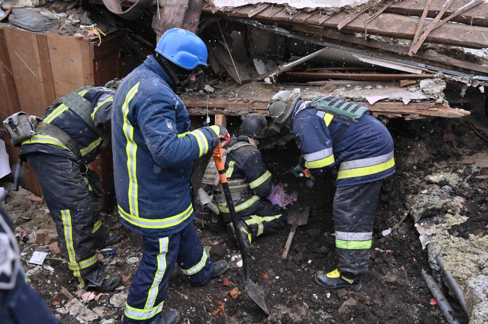 Rescuers operate on a building following Russian strikes, in Zmiiv, Kharkiv region, Ukraine. — AFP 