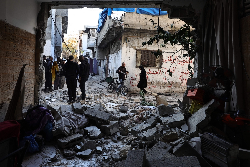 People inspect the damage following an overnight Israeli raid on the Tulkarm refugee camp in the occupied West Bank. — AFP 