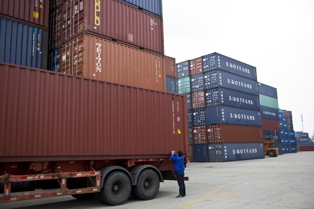 An employee takes notes at a port of Shanghai Free Trade Zone. — Reuters
