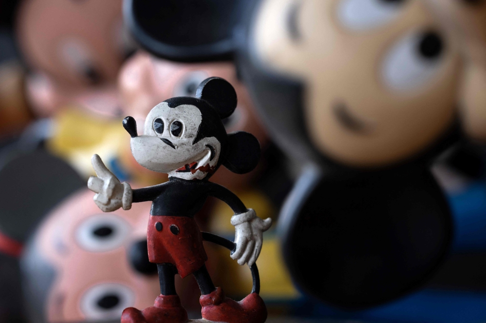 Toys bearing the image of Mickey Mouse are photographed in Paris on January 5, 2024. Under US law, the first version of the Walt Disney character Mickey Mouse entered the public domain on January 1, 2024. 

