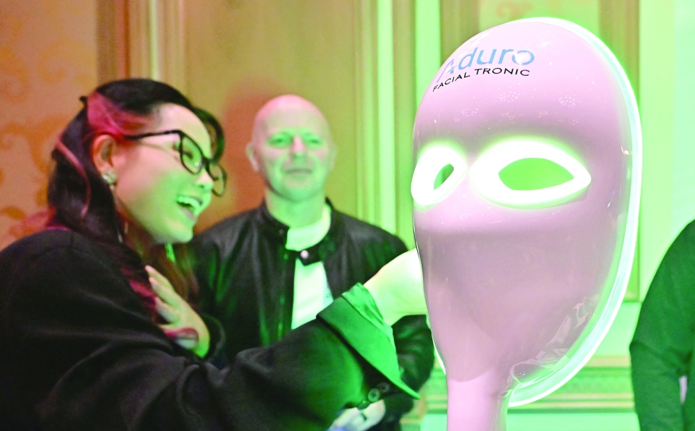 An introduction to the Aduro Facial Tronic facemask from Red Lite Therapy Collective is given during Showstoppers at the Consumer Electronics Show (CES) in Las Vegas, Nevada. - AFP