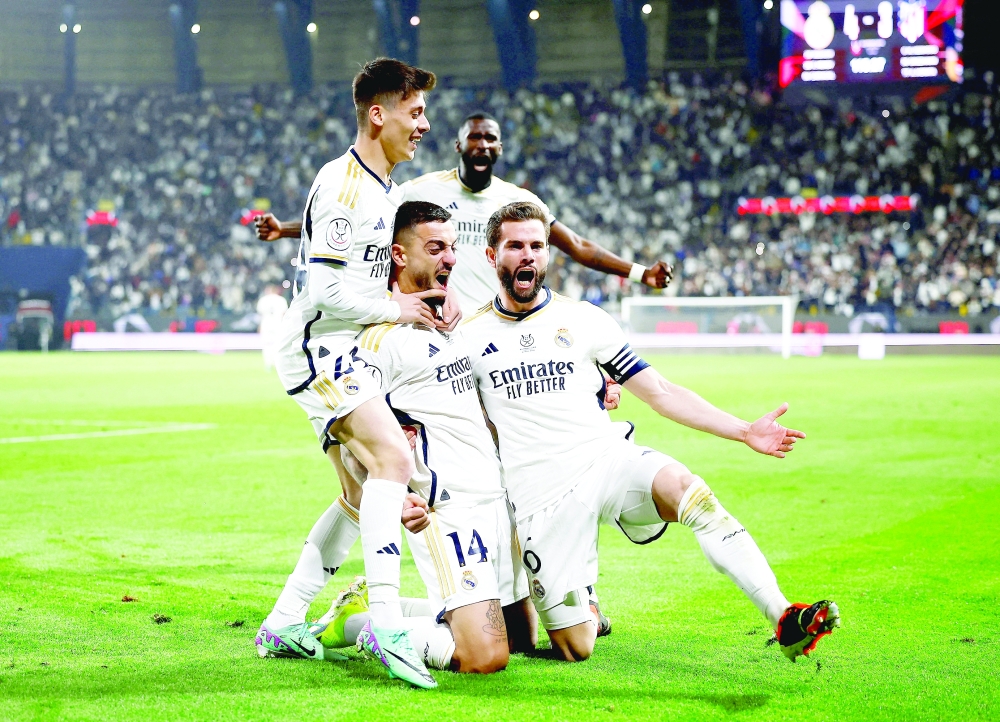 Real Madrid's Joselu and team-mates celebrate after Atletico Madrid's Stefan Savic scores an own goal and Real Madrid fourth goal REUTERS