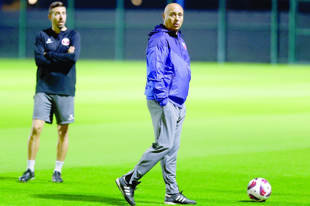 Qatar's Spanish coach Tintin Marquez (C) looks on during a training session at the Hilton Salwa Beach Resort and Villa in Abu Samrah in Qatar.
