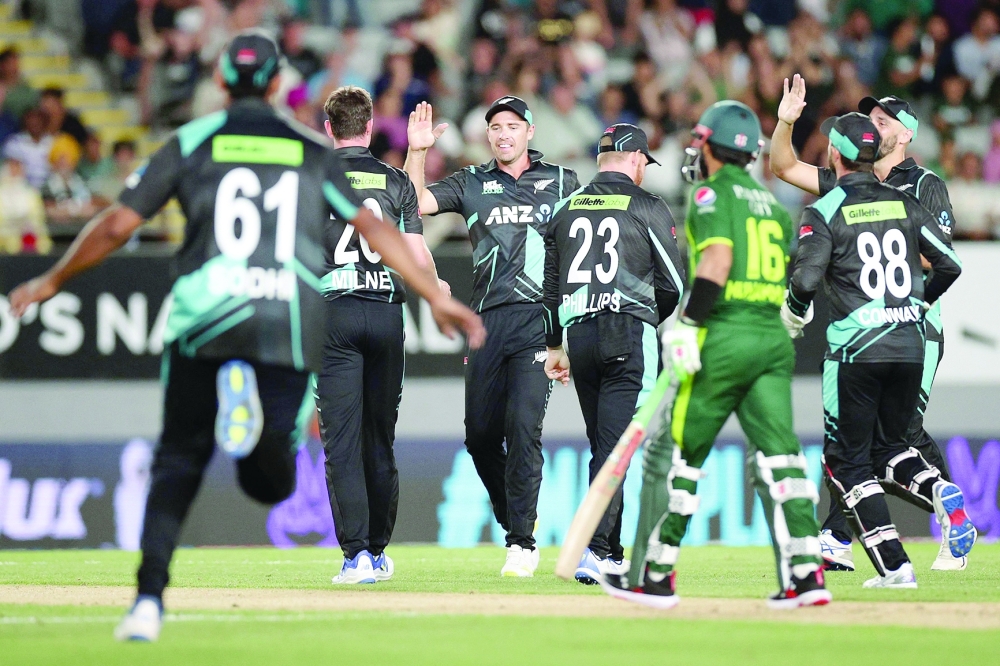 New Zealand's players celebrate the wicket of Pakistan's Saim Ayub during the first Twenty20 international cricket match between New Zealand and Pakistan at Eden Park in Auckland on January 12, 2024.  (Photo by DAVID ROWLAND / AFP)

