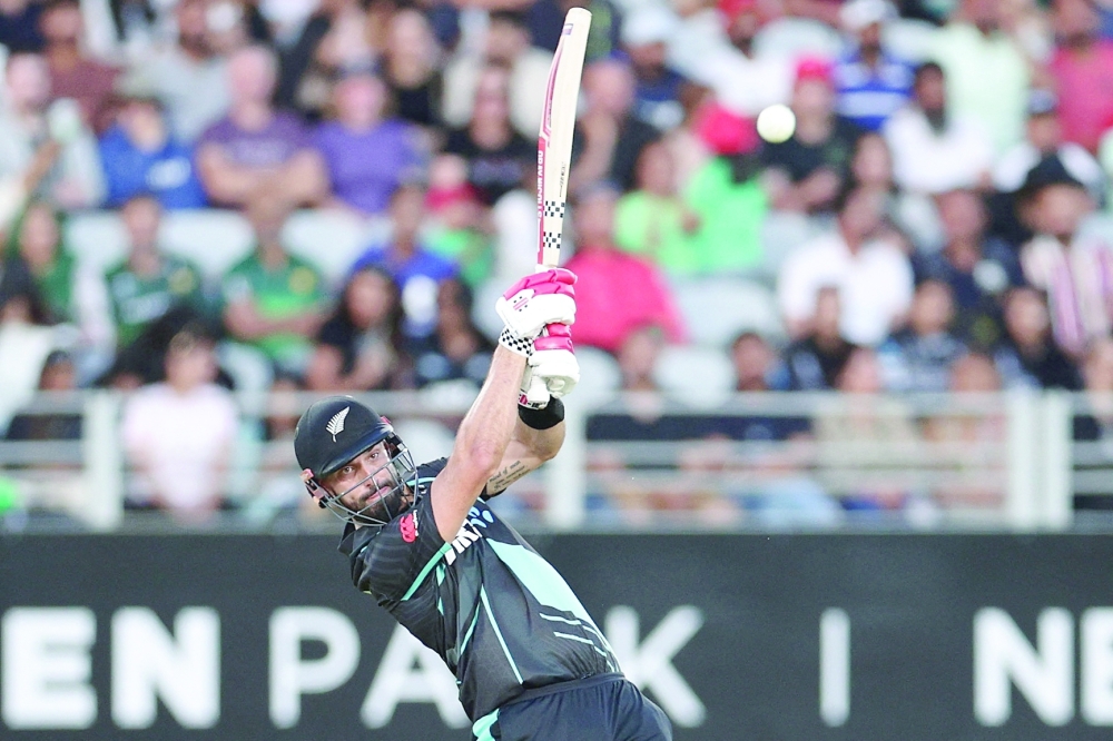 New Zealand's Daryl Mitchell plays a shot during the first Twenty20 international cricket match between New Zealand and Pakistan at Eden Park in Auckland on January 12, 2024.  (Photo by DAVID ROWLAND / AFP)

