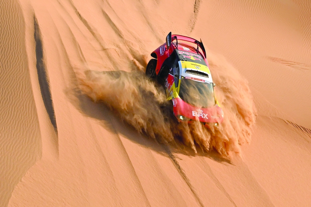 TOPSHOT - Bahrain Raid Xtreme's French driver Sebastien Loeb and Belgian co-driver Fabian Lurquin steer their car in the dunes during the second part of the 48h chrono stage between Shubaytah and Shubaytah on January 12, 2024, as part of the Dakar rally 2024. (Photo by PATRICK HERTZOG / AFP)

