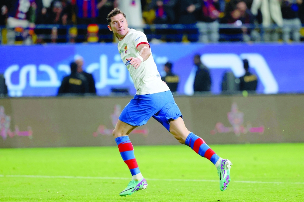 TOPSHOT - Barcelona's Polish forward #09 Robert Lewandowski celebrates scoring his team's first goal during the Spanish Super Cup semifinal football match between Barcelona and Osasuna at the Al Awwal Park Stadium in Riyadh, on January 11, 2024. (Photo by Fayez NURELDINE / AFP)