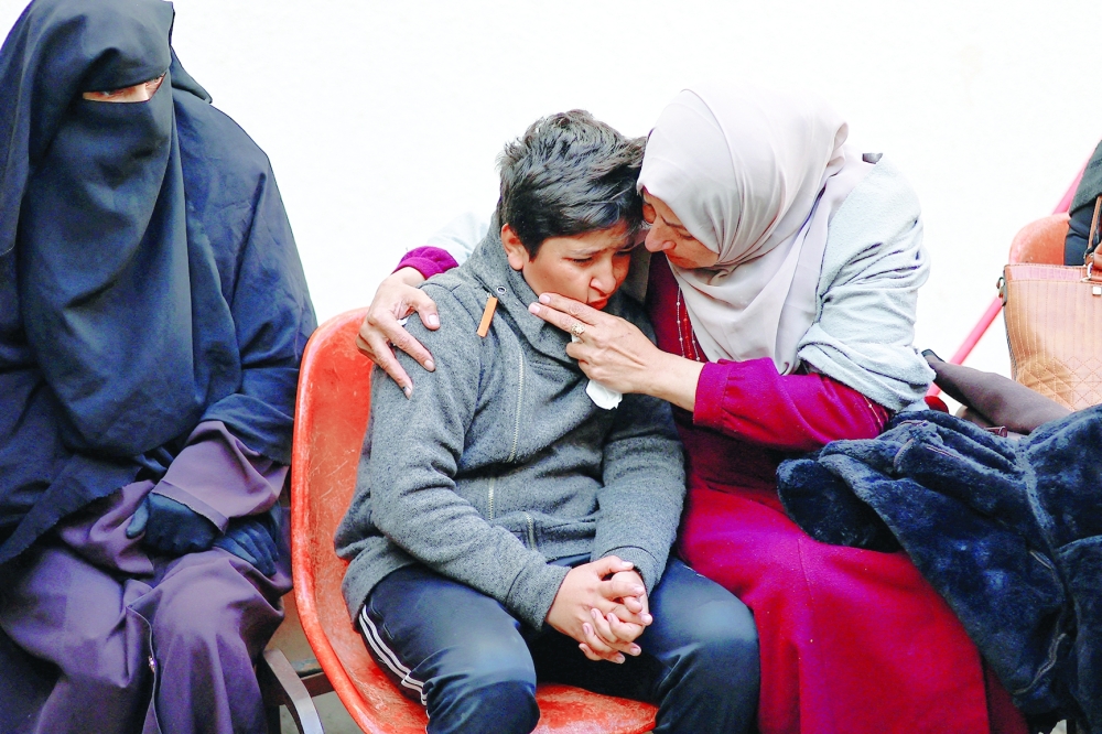 Mourners react near the bodies of Palestinians killed in an Israeli strike, at Abu Yousef al-Najjar hospital, in Rafah. — Reuters