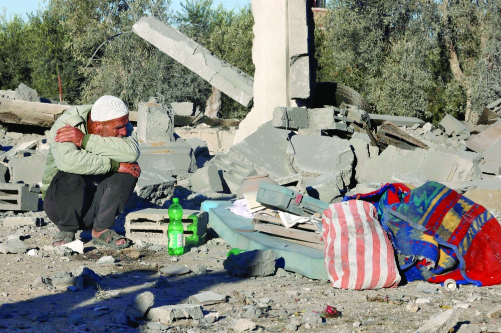 A man sits amid the rubble following Israeli bombardment in Rafah in the southern Gaza Strip. — AFP