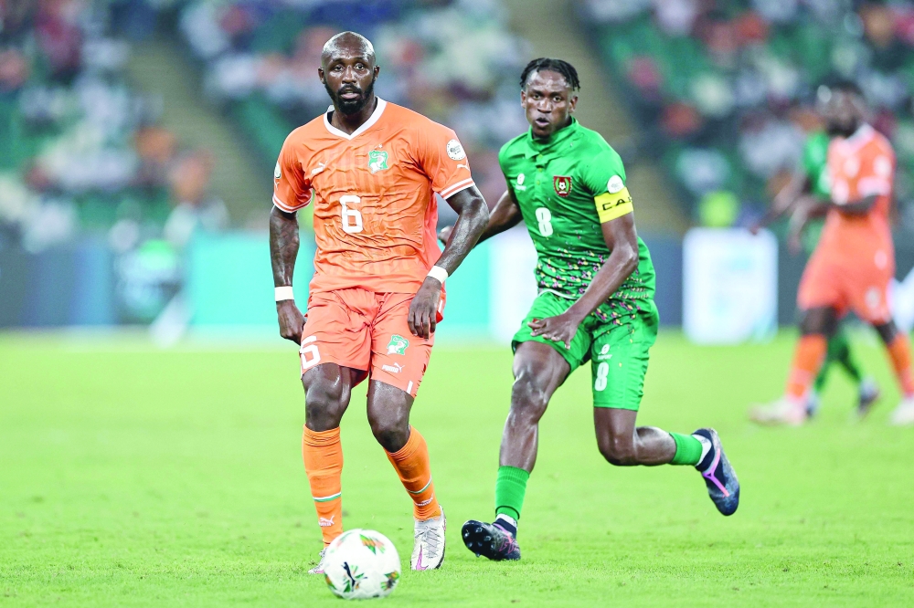 Ivory Coast's midfielder #6 Seko Fofana (L) fights for the ball with Guinea-Bissau's midfielder #8 Alfa Semedo during the Africa Cup of Nations (CAN) 2024 group A football match between Ivory Coast and Guinea-Bissau at the Alassane Ouattara Olympic Stadium in Ebimpe, Abidjan. AFP