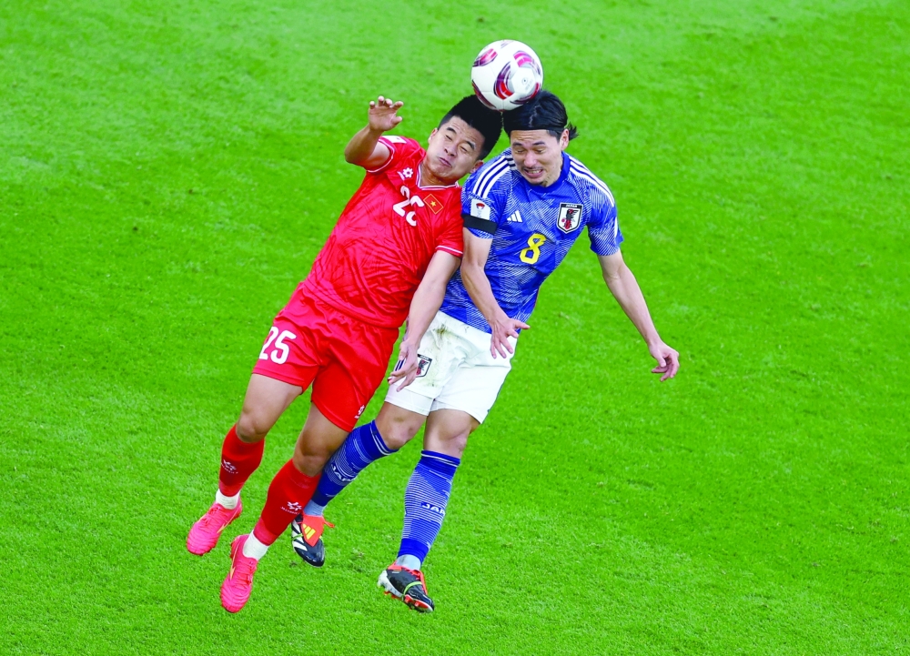 Soccer Football - AFC Asian Cup - Group D - Japan v Vietnam - Al Thumama Stadium, Doha, Qatar - January 14, 2024 Vietnam's Le Pham Thanh Long in action with Japan's Takumi Minamino. REUTERS