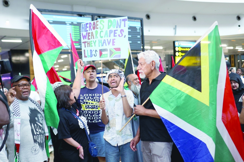 South African residents awaits for members of the South African legal team from The Hague, where they represented the country in a two-day hearing against Isreal at the International Court of Justice (ICJ), at the OR Tambo International Airport in Ekurhuleni, South Africa.  — AFP  