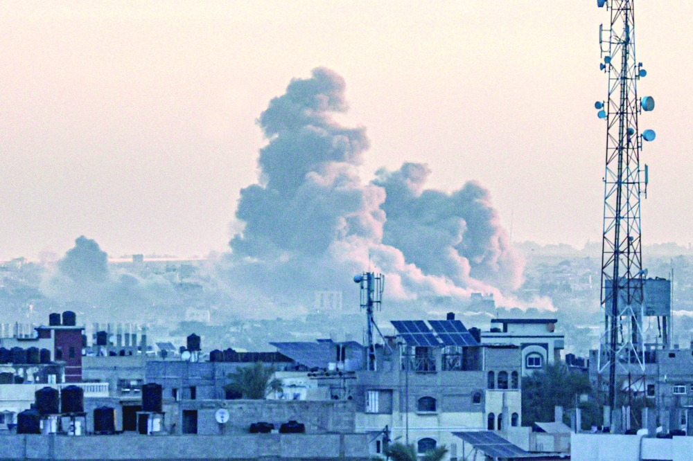 A picture taken from Rafah shows smoke billowing over Khan Yunis in the southern Gaza Strip.— AFP