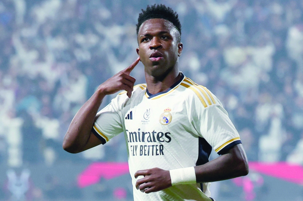 TOPSHOT - Real Madrid's Brazilian forward #07 Vinicius Junior celebrates after scoring his second goal during the Spanish Super Cup final football match between Real Madrid and Barcelona at the Al-Awwal Park Stadium in Riyadh, on January 14, 2024. 