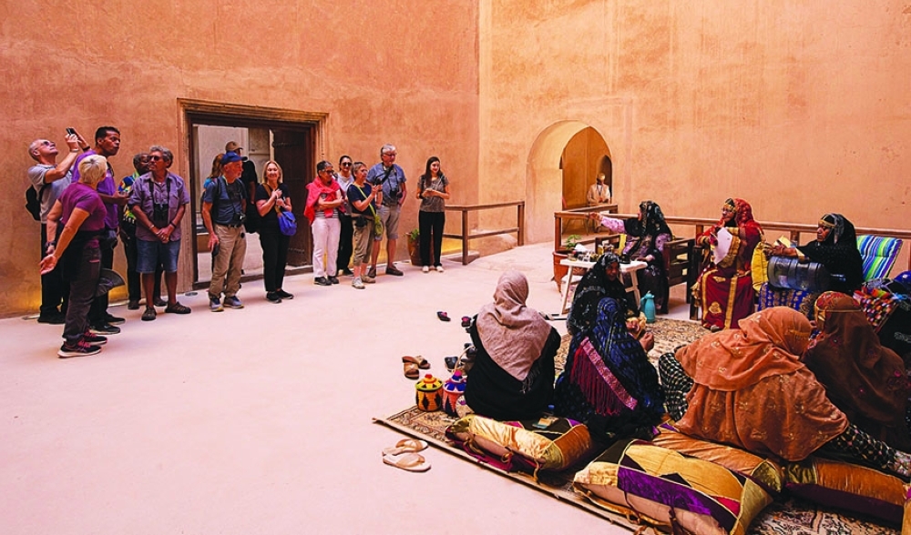 French tourists watch an example of women's folklore
