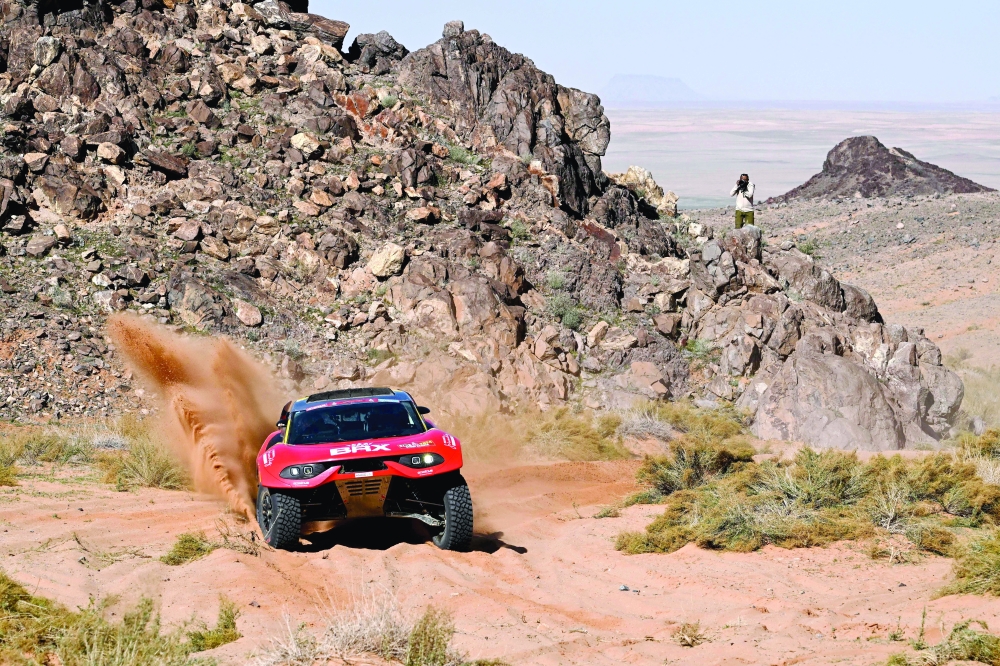 Bahrain Raid Xtreme's French driver Sebastien Loeb and his Belgian co-driver Fabian Lurquin steer their car, during stage 9 of the Dakar rally 2024 between Hail and Al Ula, Saudi Arabia, on January 16, 2024. (Photo by PATRICK HERTZOG / AFP)