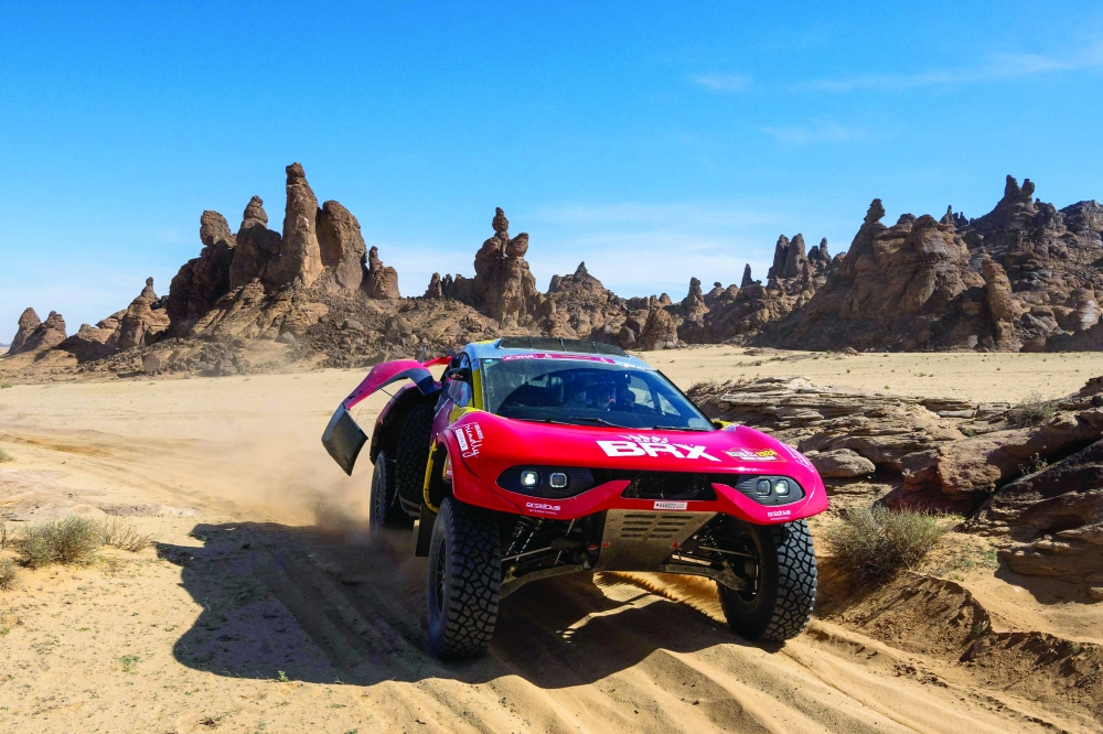 Team Bahrain Raid Xtreme's French driver Sebastien Loeb and his Belgian co-driver Fabian Lurquin steer their car, during stage 9 of the Dakar rally 2024, between Hail and Al Ula, Saudi Arabia, on January 16, 2024. (Photo by PATRICK HERTZOG / AFP)