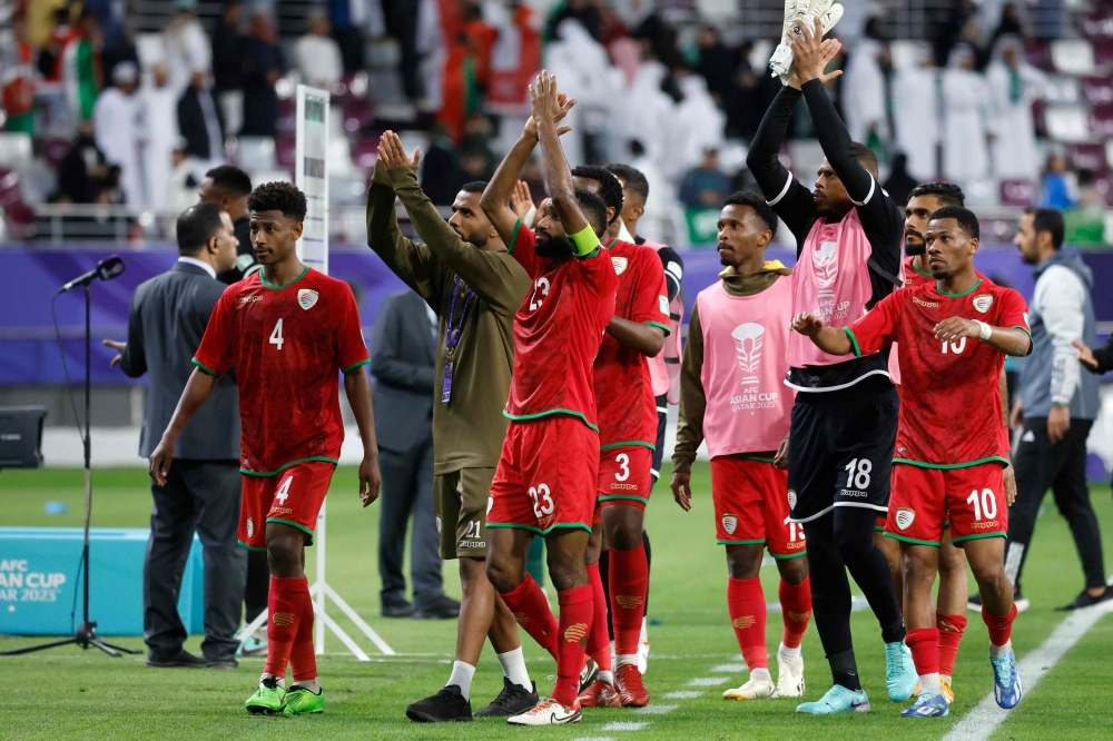 Oman's players greet their fans after the Qatar 2023 AFC Asian Cup Group F football match between Saudi Arabia and Oman at the Khalifa International Stadium in Doha on January 16, 2024.  (Photo by KARIM JAAFAR / AFP)

