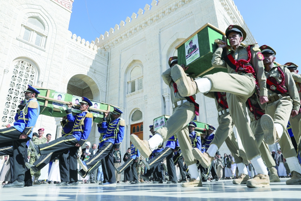 Honour guards and military cadets march as they carry coffins of fighters killed in recent US-led strikes, during their military funeral procession in Sanaa, Yemen. — Reuters