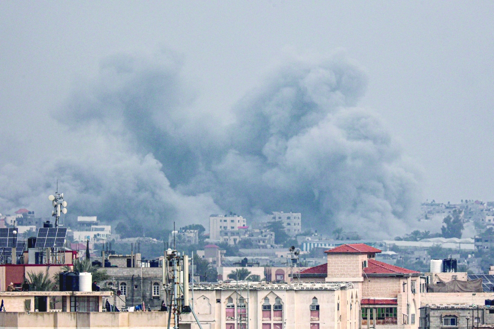 This picture shows smoke billowing over Khan Yunis in the southern Gaza Strip during Israeli bombardment. — AFP