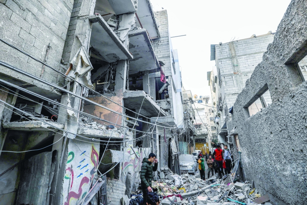 People inspect the damage following Israeli bombardment in Rafah. — AFP