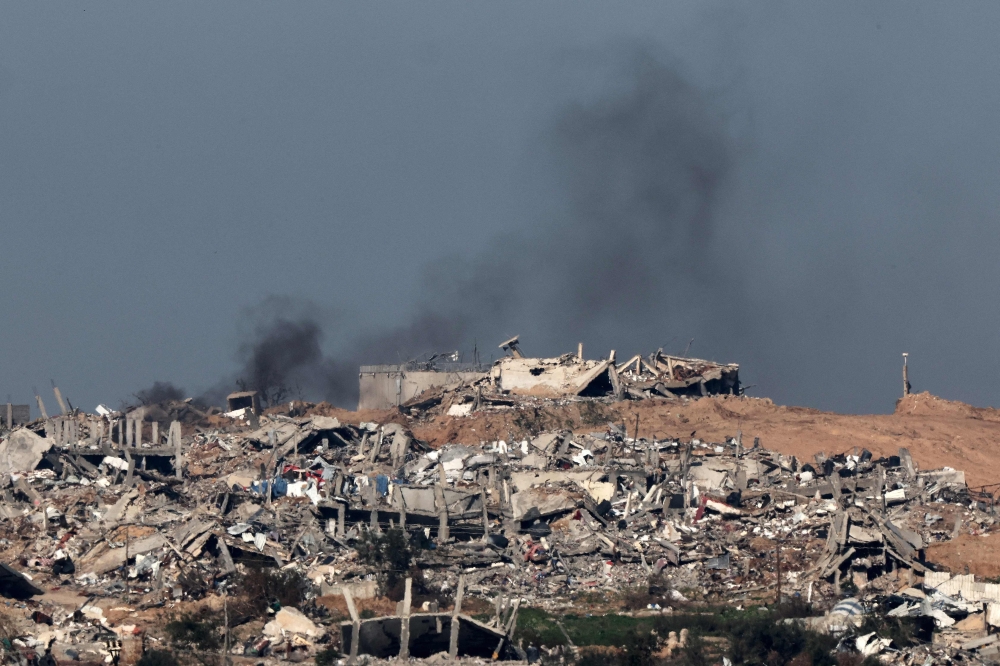 A picture taken from southern Israel shows smoke billowing over the Gaza Strip during Israeli bombardment on January 18