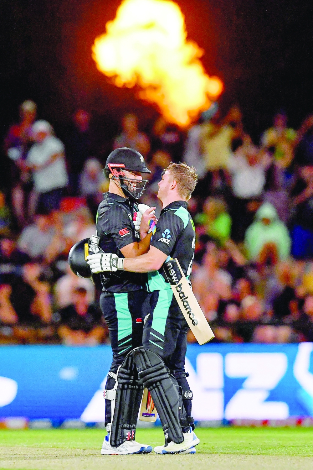 New Zealand's Daryl Mitchell (L) and New Zealand's Glenn Phillips congratulate each other at end of the fourth Twenty20 international cricket match between New Zealand and Pakistan at Hagley Oval in Christchurch on January 19, 2024.  (Photo by Sanka Vidanagama / AFP)

