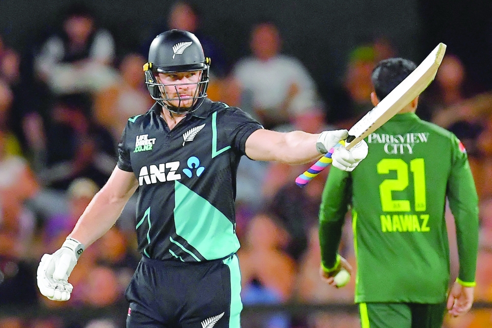 New Zealand's Glenn Phillips celebrates after scoring his half century (50 runs) during the fourth Twenty20 international cricket match between New Zealand and Pakistan at Hagley Oval in Christchurch on January 19, 2024. (Photo by Sanka Vidanagama / AFP)

