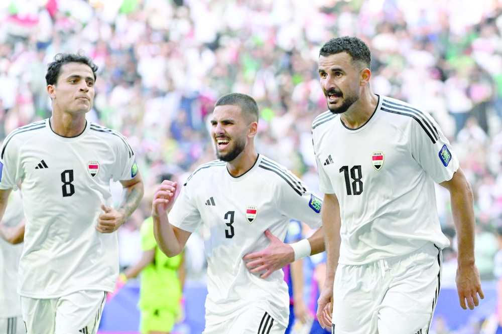 Iraq's forward #18 Aymen Hussein celebrates with team-mates after scoring his team's second goal during the Qatar 2023 AFC Asian Cup Group D football match between Iraq and Japan at the Education City Stadium in Al Rayyan, west of Doha on January 19, 2024.  (Photo by HECTOR RETAMAL / AFP)