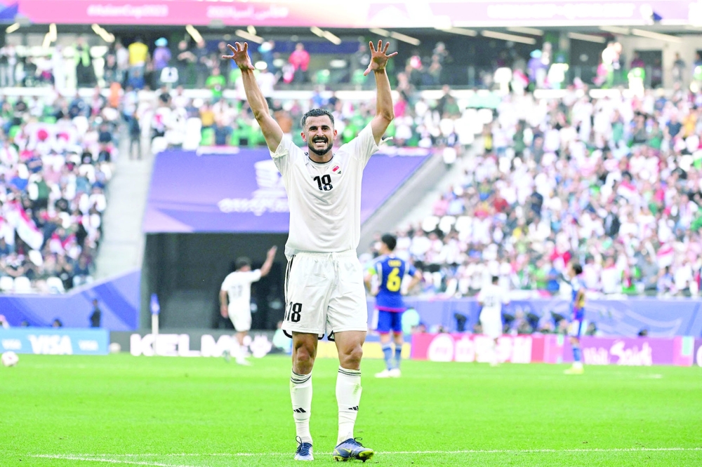 Iraq's forward #18 Aymen Hussein celebrates after scoring his team's second goal during the Qatar 2023 AFC Asian Cup Group D football match between Iraq and Japan at the Education City Stadium in Al Rayyan, west of Doha on January 19, 2024.  (Photo by HECTOR RETAMAL / AFP)