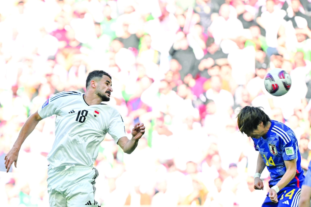 Iraq's forward #18 Aymen Hussein heads the ball to score his team's first goal during the Qatar 2023 AFC Asian Cup Group D football match between Iraq and Japan at the Education City Stadium in Al Rayyan, west of Doha on January 19, 2024.  (Photo by HECTOR RETAMAL / AFP)