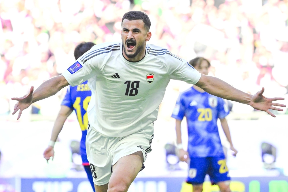 Iraq's forward #18 Aymen Hussein celebrates after scoring his team's first goal during the Qatar 2023 AFC Asian Cup Group D football match between Iraq and Japan at the Education City Stadium in Al Rayyan, west of Doha on January 19, 2024.  (Photo by HECTOR RETAMAL / AFP)