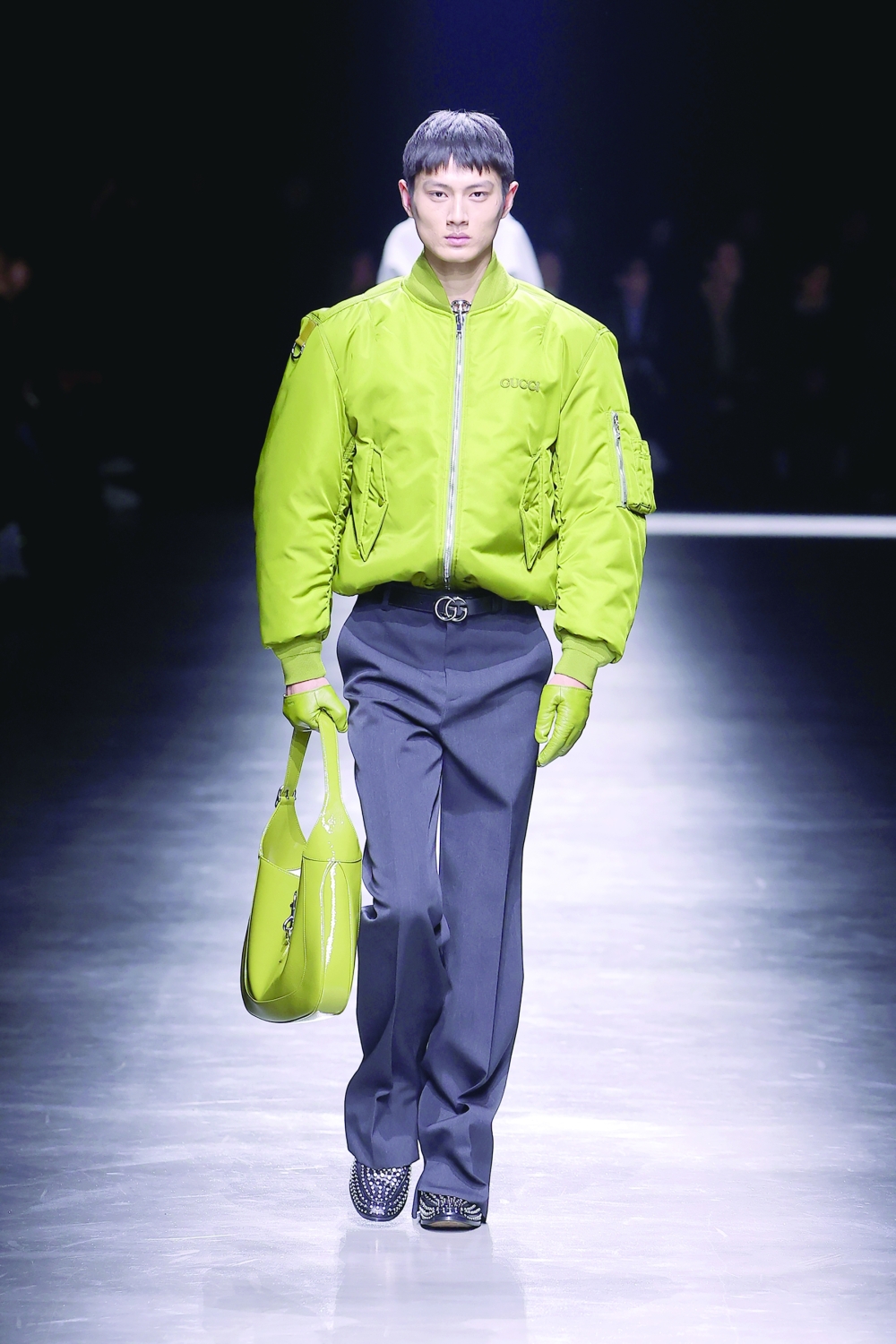 In a photo from Gucci, a model walks the runway at the Gucci collection menswear show during the Milan Fashion Week. 