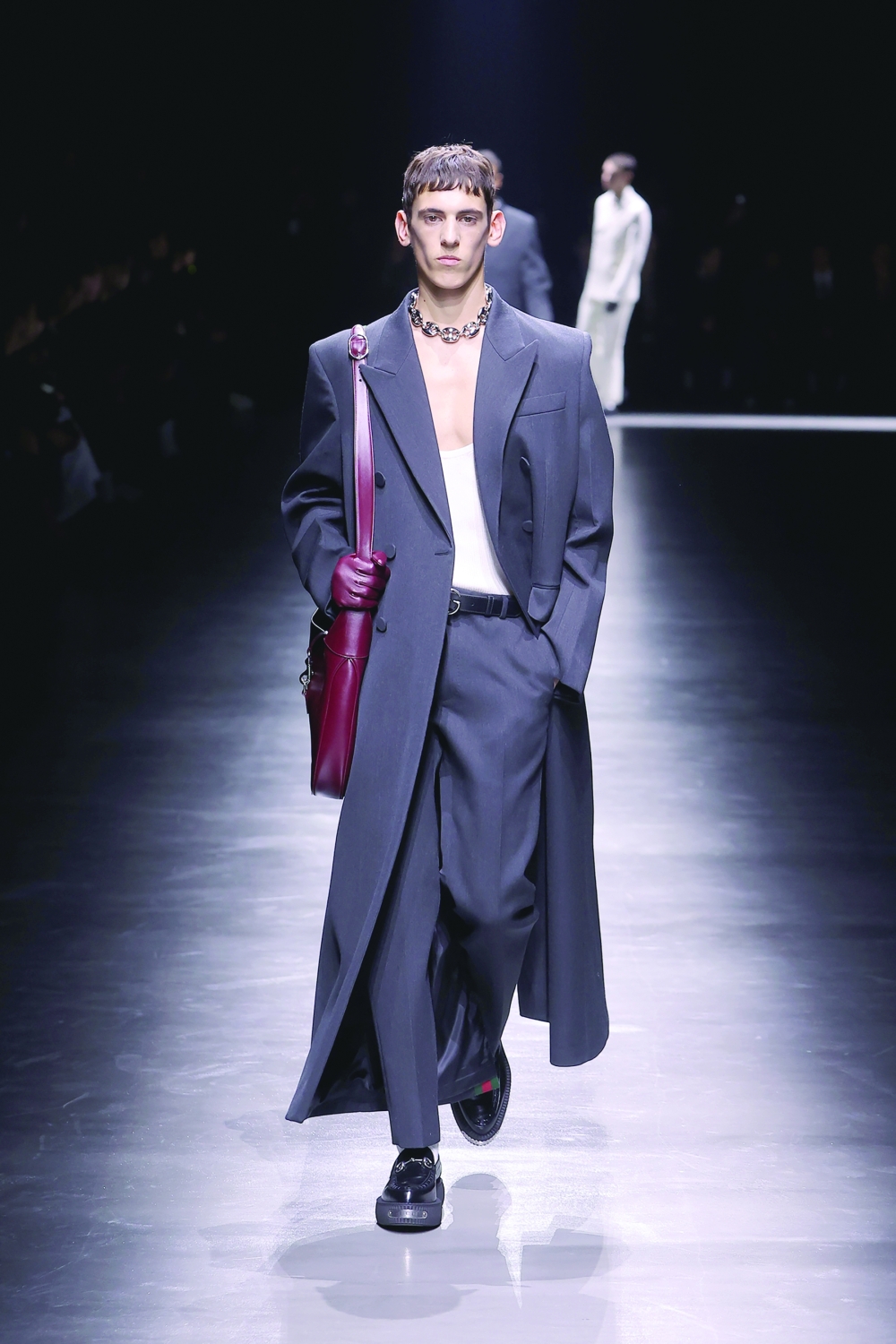 In a photo from Gucci, a model walks the runway at the Gucci collection menswear show during the Milan Fashion Week. 