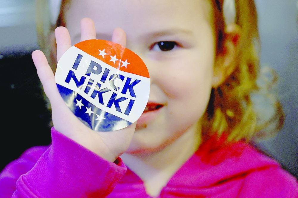 A young diner holds up an "I Pick Nikki" sticker during Republican presidential candidate Nikki Haley’s campaign in Amherst, New Hampshire, US. - Reuters